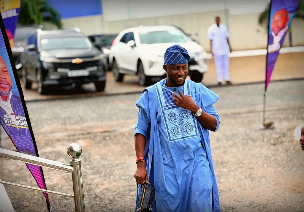 A member smiling warmly while arriving at church