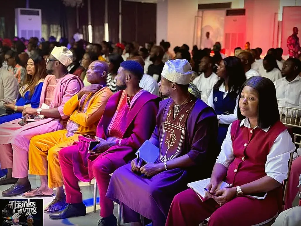 A vibrant, colorfully dressed congregation gathered for a Thanksgiving service
