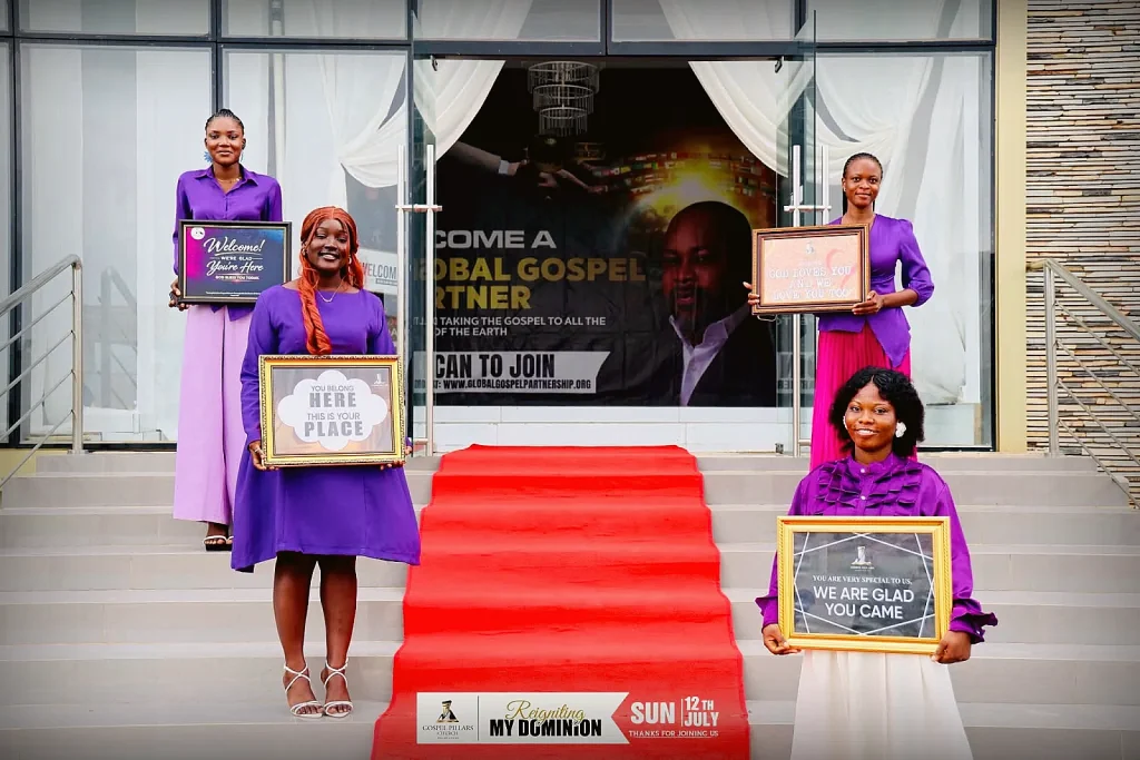 Ushers welcoming guests with signs at the church entrance