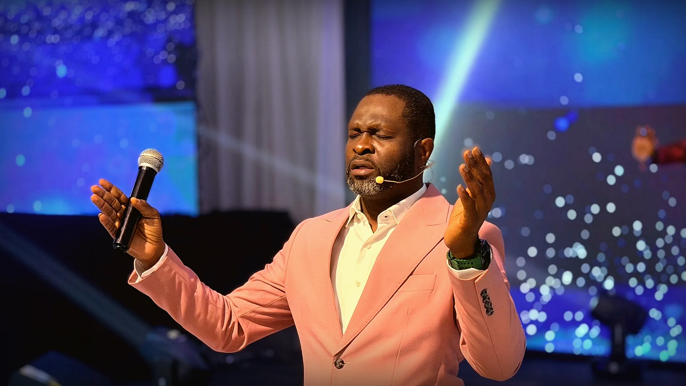 Apostle ministering during worship at Gospel Pillars Church Accra